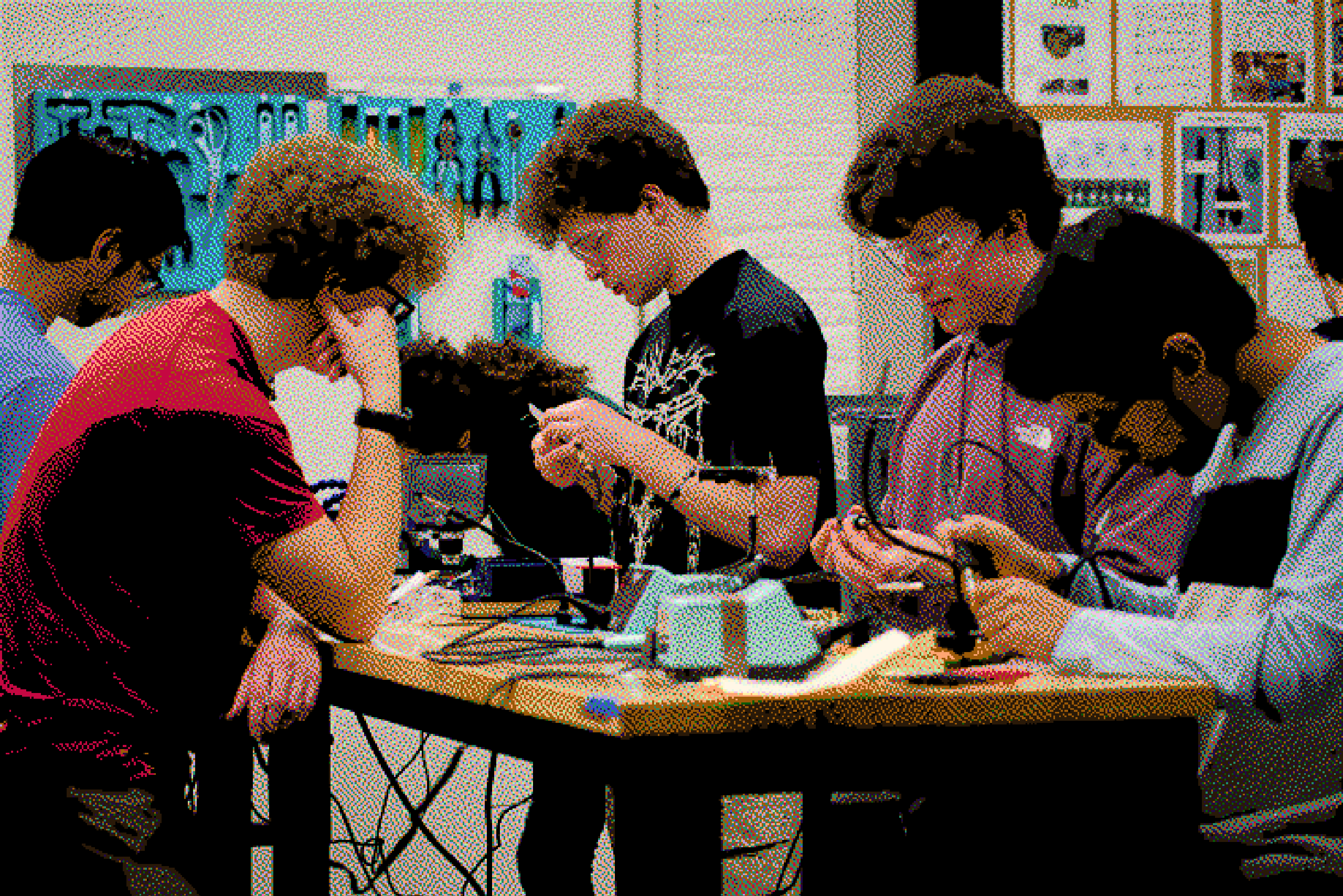 Club members working together at a soldering workshop